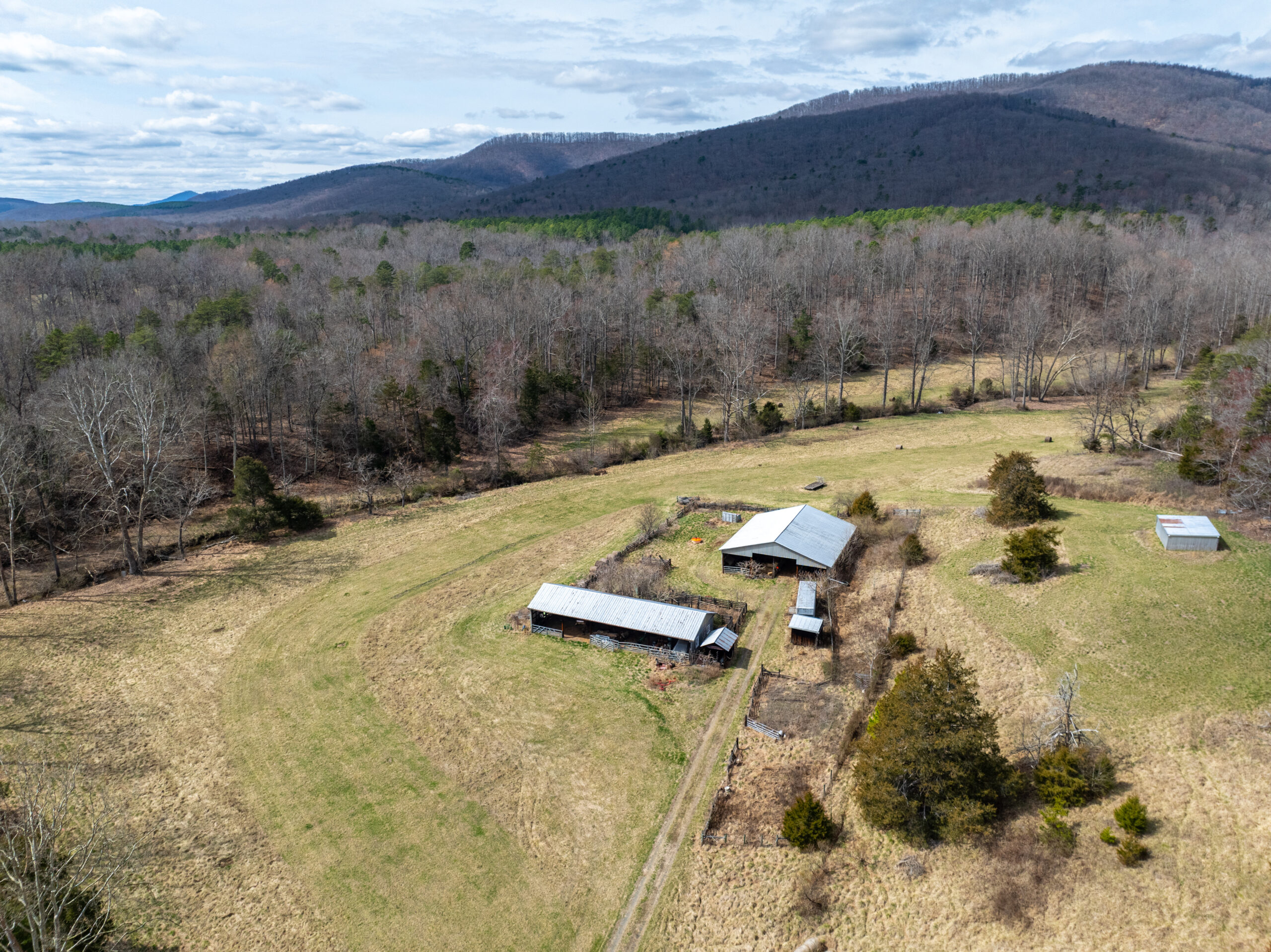 farmland and barns with mountains in background