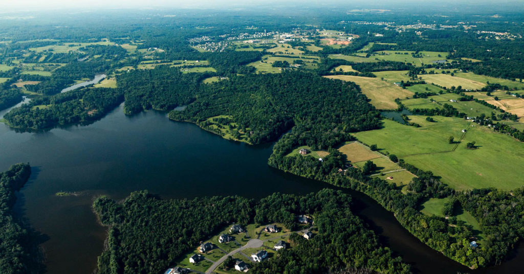 aerial view of lake, forests and farmland