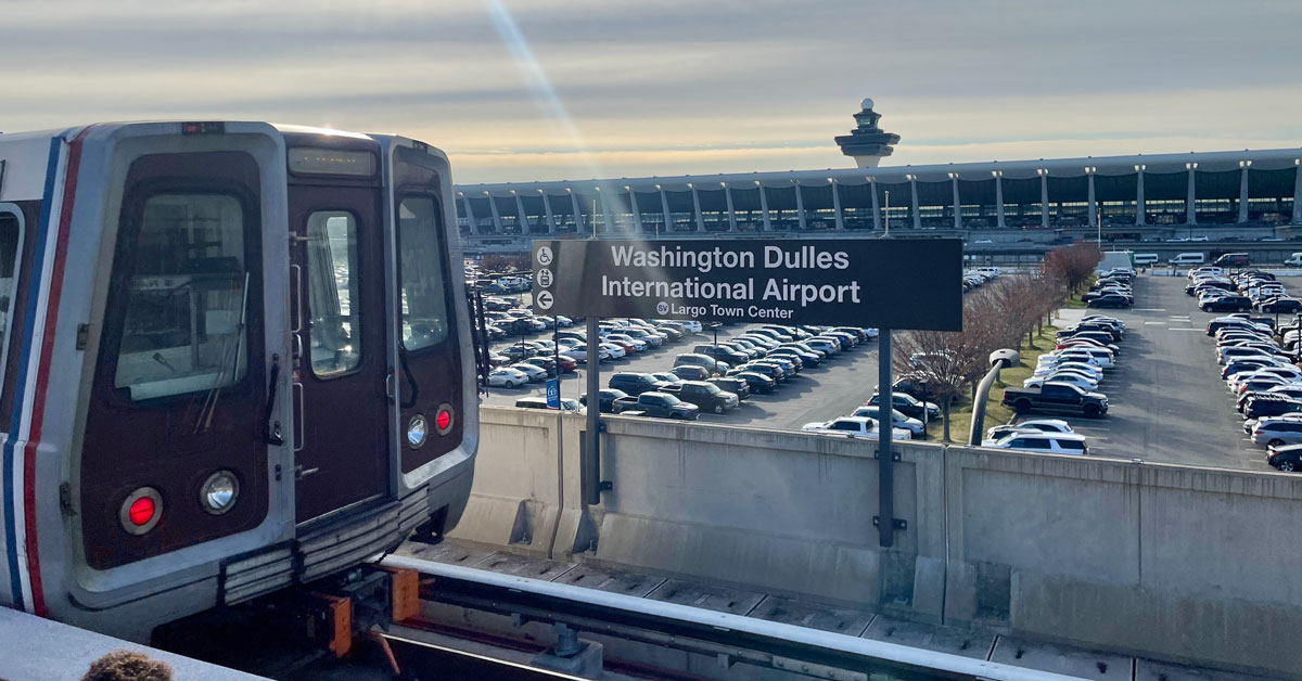 front of metro car with view of Dulles airport in background