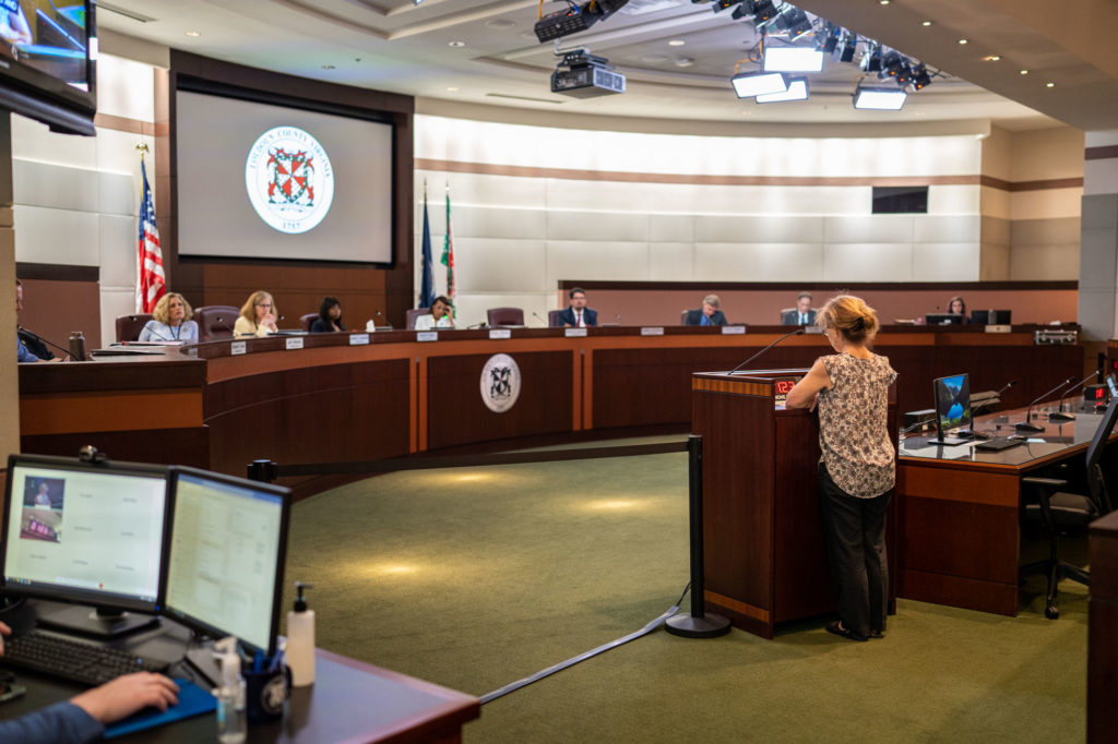 Gem Bingol speaking to the Board of Supervisors.